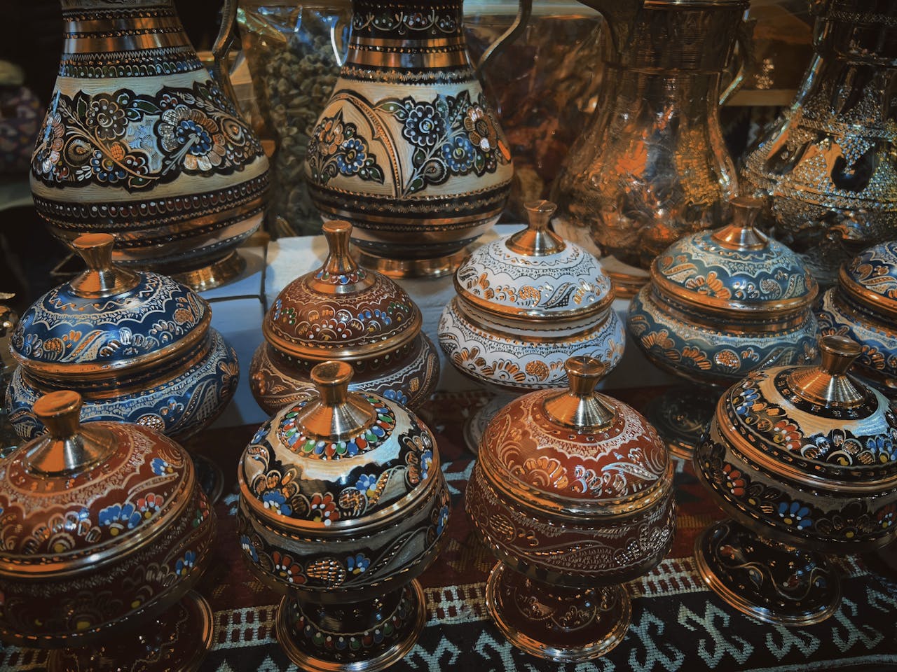 Showcase of intricate handcrafted pottery with vibrant designs. Perfect for traditional decor enthusiasts.
